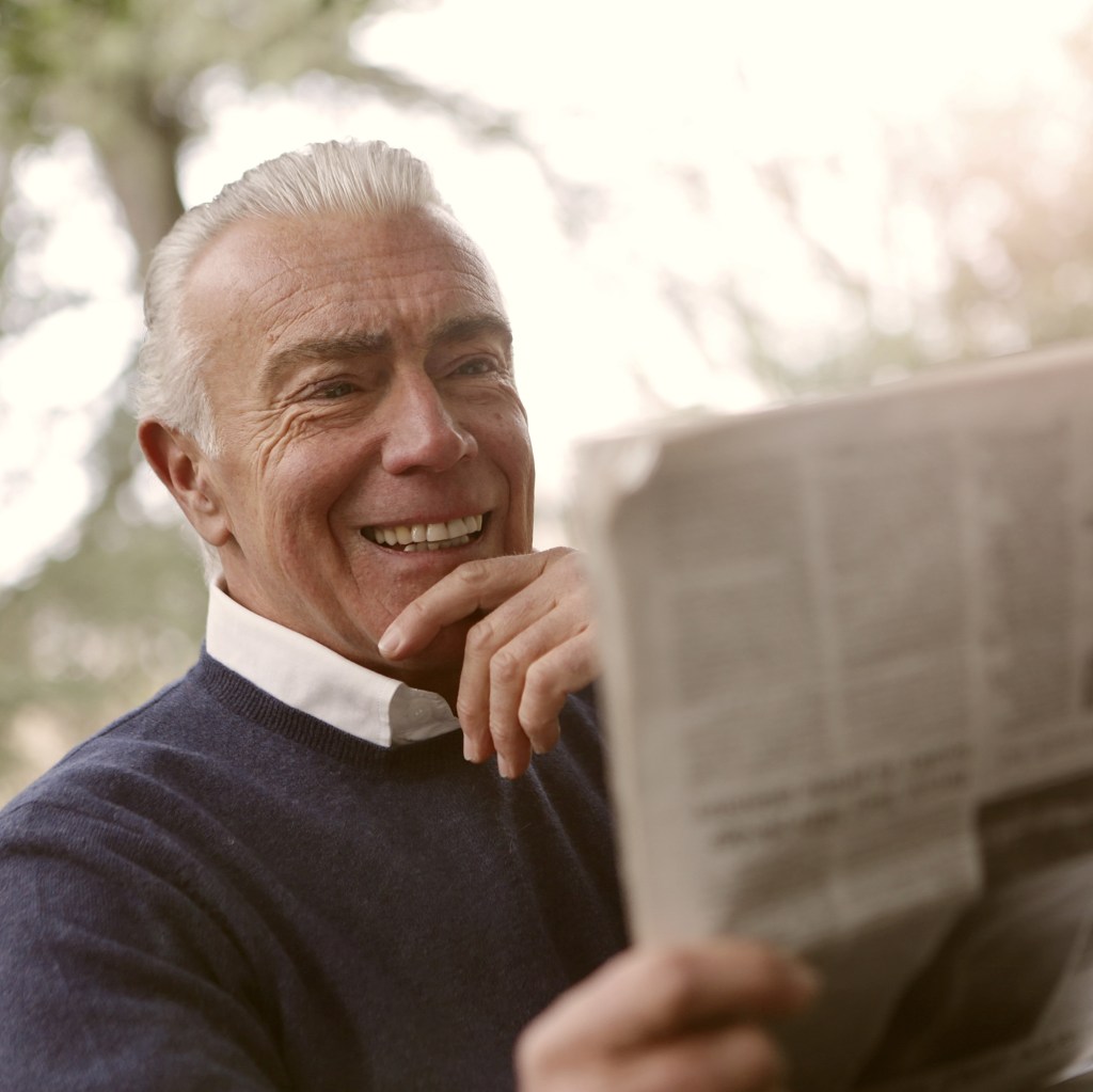 senior man reading newspaper